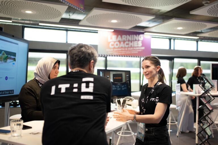 Female Learning Coach talking to people